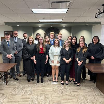 image of klop students with judges in a courtroom